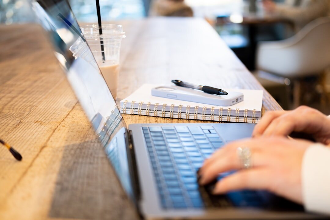 Journalist taking notes on a laptop during a press event